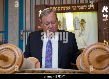 170424-N-WC566-0039 PEARL HARBOR (April 24, 2017)  Dr. Daniel A Bender, volunteer lay leader at the Aloha Jewish Chapel, exhibits a hand made Torah scroll during a Holocaust Remembrance Ceremony held at Joint Base Pearl Harbor-Hickam. The scroll was hand written in Hebrew, and was made and donated specially to the Aloha Jewish Chapel. This year’s theme is, “The Strength of the Human Spirit”, and featured Dr. Bender as the guest speaker. (U.S. Navy Photo by Mass Communications Specialist 2nd Class Gabrielle Joyner) Stock Photo