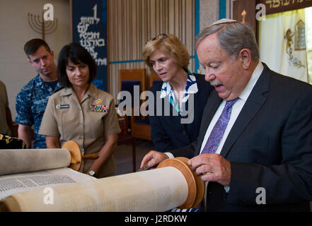 170424-N-WC566-0042 PEARL HARBOR (April 24, 2017)  Dr. Daniel A Bender, volunteer lay leader at the Aloha Jewish Chapel, shows military and civilian observers a hand made Torah scroll during a Holocaust Remembrance Ceremony held at Joint Base Pearl Harbor-Hickam. The scroll was hand written in Hebrew, and was made and donated specially to the Aloha Jewish Chapel. This year’s theme is, “The Strength of the Human Spirit”, and featured Dr. Bender as the guest speaker.(U.S. Navy Photo by Mass Communications Specialist 2nd Class Gabrielle Joyner) Stock Photo