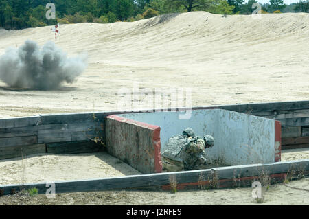 Staff Sgt. Jason Pickard, Headquarters and Headquarters Detachment, 415th Chemical Battalion, 76th Division Operational Command, tests his skill during the live hand grenade qualification portion of the Combined Best Warrior Competition at Joint Base McGuire-Dix-Lakehurst, N.J. April 27, 2017. The 14 contestants must demonstrate how to deploy a live grenade properly to add to their score and hopefully take the title of Best Warrior or Best Noncommissioned Officer and move on to represent the 412th Theater Engineer Command,  416th Theater Engineer Command and 76th Operational Response at the US Stock Photo