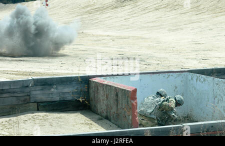 Staff Sgt. Jason Pickard, Headquarters and Headquarters Detachment, 415th Chemical Battalion, 76th Division Operational Command, tests his skill during the live hand grenade qualification portion of the Combined Best Warrior Competition at Joint Base McGuire-Dix-Lakehurst, N.J. April 27, 2017. The 14 contestants must demonstrate how to deploy a live grenade properly to add to their score and hopefully take the title of Best Warrior or Best Noncommissioned Officer and move on to represent the 412th Theater Engineer Command,  416th Theater Engineer Command and 76th Operational Response at the US Stock Photo