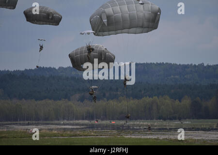 Sky Soldiers from C Company, 2nd Battalion, 503rd Infantry Regiment, 173rd Airborne Brigade conducted a joint airborne operation and airfield seizure with the Czech Republic Army during a joint field exercise as a part of Exercise Saber Junction 17 in Mimon, Czech Republic April 17, 2017. Exercise Saber Junction demonstrates the ability of the 173rd Airborne Brigade to quickly move and assemble its forces in collaboration with NATO allies to secure critical assets, which enables following forces to air land crucial equipment. Stock Photo