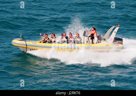 A rigid-hulled inflatable boat (RHIB), rigid-inflatable boat (RIB) is a lightweight but high-performance stable and seaworthy boat Stock Photo