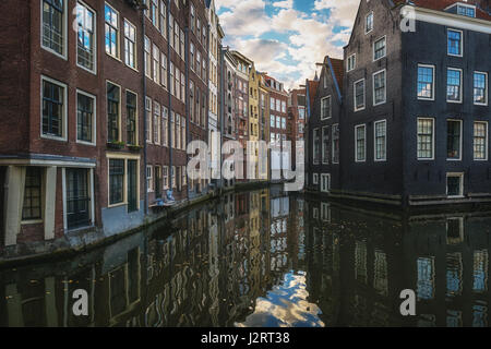 Amsterdam, Netherlands – October 30, 2016: The canal houses along the junction of the canals Oudezijds Voorburgwal and Oudezijds Achterburgwal in the  Stock Photo