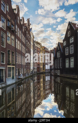 Amsterdam, Netherlands – October 30, 2016: The canal houses along the junction of the canals Oudezijds Voorburgwal and Oudezijds Achterburgwal in the  Stock Photo