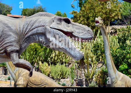 Algar, Spain - April 8, 2017: Realistic models of a Tyrannosaurus Rex and Diplodocus dinosaurus in the Dino Park of Algar. It is a unique entertainmen Stock Photo