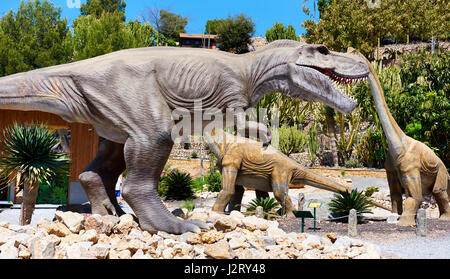 Algar, Spain - April 8, 2017: Realistic models of a Tyrannosaurus Rex and Diplodocus dinosaurus in the Dino Park of Algar. It is a unique entertainmen Stock Photo