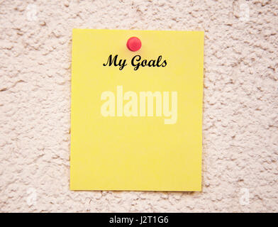 Yellow notepad on the wall With the words my goals Stock Photo