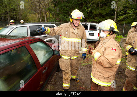 Trainee fire fighter and Howe Sound Secondary student Kei Gray works on a vehicle extraction exercise during the Junior Fire Academy. Stock Photo