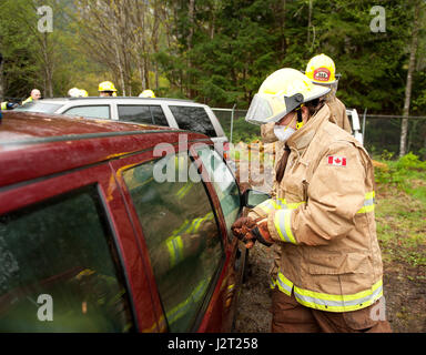 Trainee fire fighter and Howe Sound Secondary student Kei Gray works on a vehicle extraction exercise during the Junior Fire Academy. Stock Photo