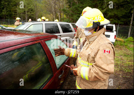 Trainee fire fighter and Howe Sound Secondary student Kei Gray works on a vehicle extraction exercise during the Junior Fire Academy. Stock Photo