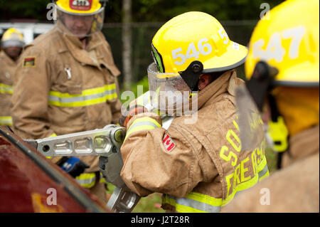 Trainee fire fighter and Howe Sound Secondary student Kei Gray uses the Jaws of Life during a vehicle extraction exercise. Stock Photo