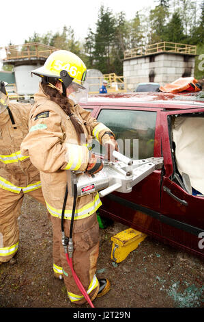 Trainee fire fighter and Howe Sound Secondary student Kei Gray uses the Jaws of Life during a vehicle extraction exercise. Stock Photo