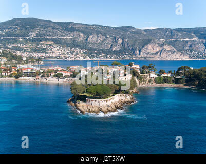 AERIAL VIEW. Seaside resort of Saint-Jean-Cap-Ferrat, Beaulieu-sur-Mer in the distance. Alpes-Maritimes, Provence-Alpes-Côte d'Azur, France. Stock Photo