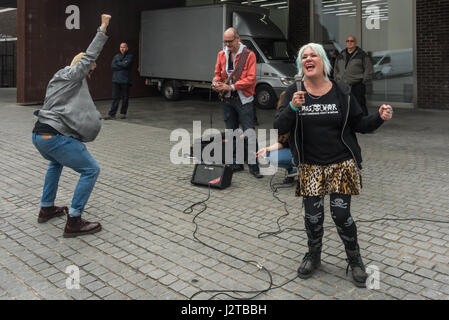 London, UK. 30th April 2017. Jane Nicholl recites as an introduction to a performance by Adam Clifford (aka Jimmy Kunt) at the Class War protest against gentrification outside Bermondsey's White Cube gallery. There were also performances by Cosmo, Potent Whisper nd others, along with speeches by Simon Elmer of ASH, Martin Wright and Ian Bone. Credit: Peter Marshall/Alamy Live News