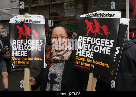 London, UK. 1st May, 2017. May Day March London UK a woman holding placards Credit: Brian Southam/Alamy Live News Stock Photo
