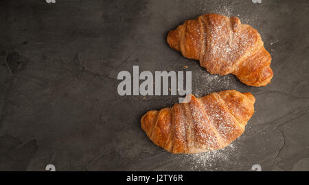 Top View of two fresh croissants on grey slate Stock Photo