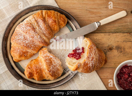 Top view of fresh croissants on a breakfast table settin Stock Photo