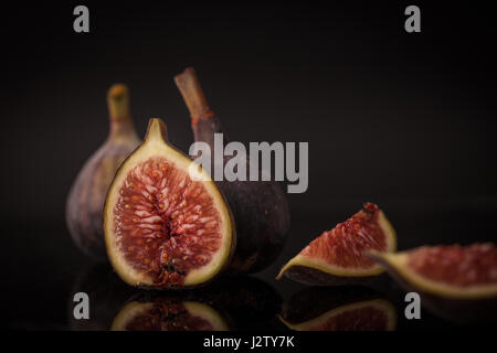 Figs on a reflective black surface Stock Photo