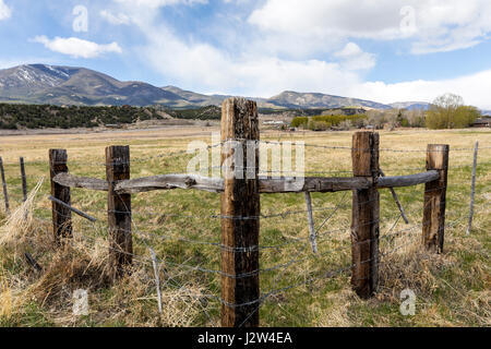 Wooden fencepost and barbed wire; Vandaveer Ranch; Salida; Colorado; USA Stock Photo