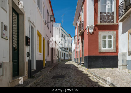 Traditional cobbled street in Tavira old town in the Algarve, Portugal Stock Photo
