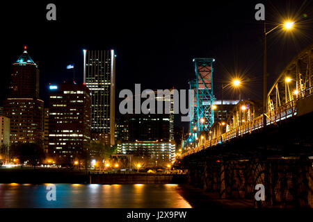 Night Quay downtown Portland and road footbridge over the River Willamette in the night illumination of colored lights and reflections entering Stock Photo
