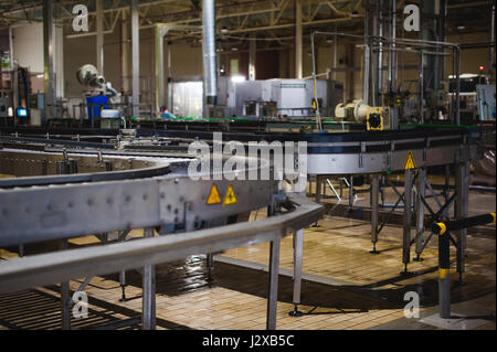 Beer production line. Equipment for the staged production and bottling of the finished product. Special industrial technological device at the factory Stock Photo