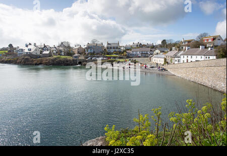 MOELFRE-  APRIL 1st 2017: Moelfre bay in Anglesey, North Wales. People enjoying a sunny day at the beach.  Moelfre Bay, UK April 1st, 2017 Stock Photo