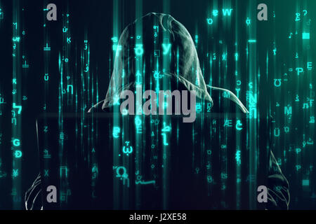 Hooded unrecognizable hacker and cyber criminal working on laptop, programming bugs and viruses for computers, matrix like code is overlaying image Stock Photo