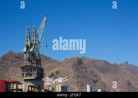 Harbor crane with a mountain in the background. Stock Photo