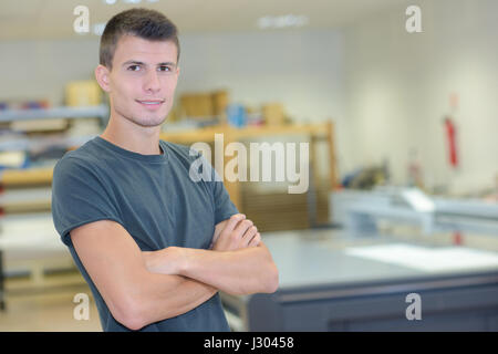 Portrait of young man with arms folded Stock Photo