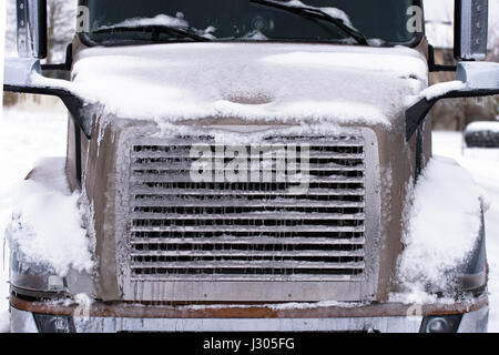 Details of modern large brown truck. Winter truck covered with ice and snow Stock Photo