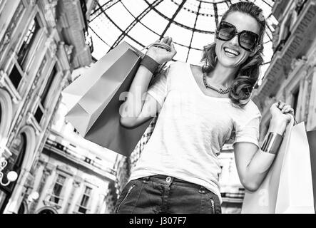 Discover most unexpected trends in Milan. Happy fashion woman with colorful shopping bags in Galleria Vittorio Emanuele II Stock Photo