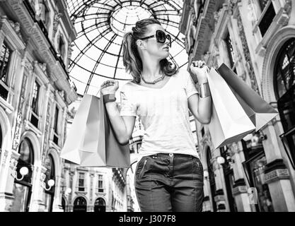 Discover most unexpected trends in Milan. Fashion monger with colorful shopping bags in Galleria Vittorio Emanuele II Stock Photo