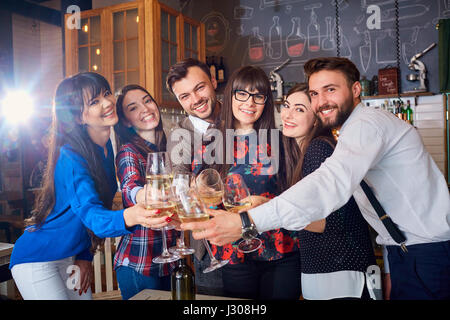 Friends with glasses at the celebration in restaurant have fun a Stock Photo