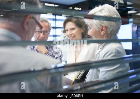 Business people in office lobby through a window Stock Photo