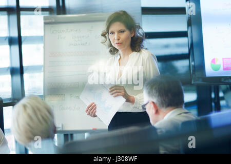 Business presentation by female coworker Stock Photo