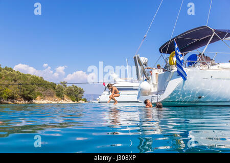 Children jumping from the sailboat Stock Photo