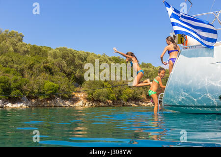 Children jumping from the sailboat Stock Photo