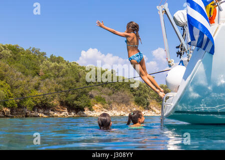 Children jumping from the sailboat Stock Photo