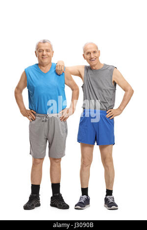 Full length portrait of two mature men dressed in sportswear looking at the camera isolated on white background Stock Photo