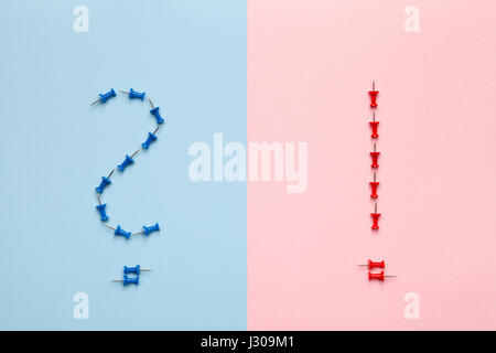 Question and exclamation marks on pastel background. Minimal style. Flat lay. Top view Stock Photo