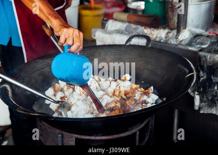 GEORGE TOWN, MALAYSIA - MARCH 23, 2016: Man is cooking at Kimberly Street Food Night Market on March 23, 2016 in George Town, Malaysia. Stock Photo