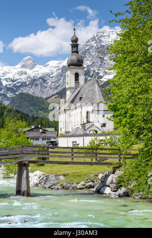 Scenic mountain landscape in the Bavarian Alps with famous Parish Church of St. Sebastian in the village of Ramsau in springtime, Bavaria, Germany Stock Photo