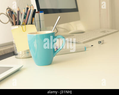 Cup of coffee on a workspace of a creative person Stock Photo