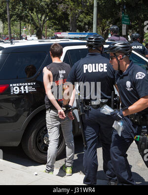 Los Angeles, California, USA. 1st May, 2017. Anti-Trump protester is arrested by Los Angeles Police Department officers near Los Angeles City Hall in downtown Los Angeles, California on May 1, 2017.  Credit: Sheri Determan/Alamy Live News Stock Photo