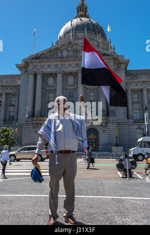 San Francisco, California, USA. 1st May, 2017. An immigrant man stands proudly before San Francisco City Hall holding the flag of his native Yemen. On May 1, 2017, more than 40 cities in the U.S.A. staged protest events for the 'Day Without an Immigrant.' In San Francisco alone, thousands took to the streets to protest Trump's immigration policies and show support for immigrant rights. Credit: Shelly Rivoli/Alamy Live News Stock Photo
