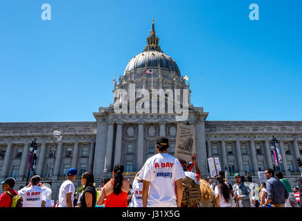 San Francisco, California, USA. 1st May, 2017. A man wears the 'A Day Without Immigrants' commemorative T-shirt before San Francisco City Hall as the May 1, 2017, Day Without Immigrants march ends at Civic Center Plaza. More than 40 cities in the U.S.A. staged protest events for the 'Day Without an Immigrant.' In San Francisco alone, thousands took to the streets to protest Trump's immigration policies and show support for immigrant rights. Credit: Shelly Rivoli/Alamy Live News Stock Photo