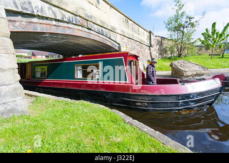 People coming through a bridge into Trevor Basin on the Llangollen Canal in North Wales on a canal boart rental from Anderson Boats Stock Photo
