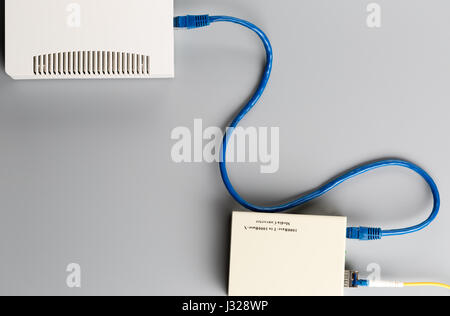 1Gbps optical media converter with SFP module connected to ethernet port office hub Stock Photo