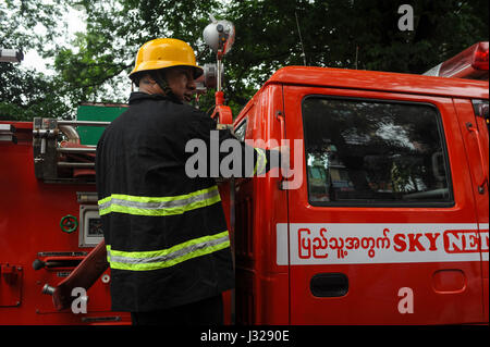 30.07.2013, Yangon, Republic of the Union of Myanmar, Asia - A fire fighter rushes to an emergency operation in the centre of the former capital. Stock Photo